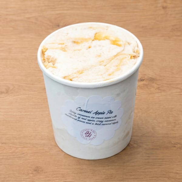A pint of "Carmel Apple Pie" ice cream with a label describing its ingredients.