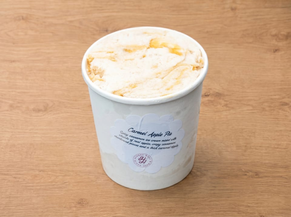 A pint of "Carmel Apple Pie" ice cream with a label describing its ingredients.